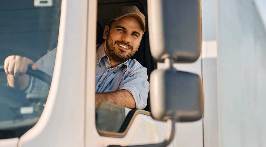 happy trucker driving a semi bought with zero down financing